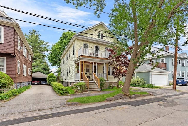 56 Hilton St Unit 56, Arlington, MA 02474 - view of front of house with a garage, a balcony, an outbuilding, covered porch, and cooling unit
