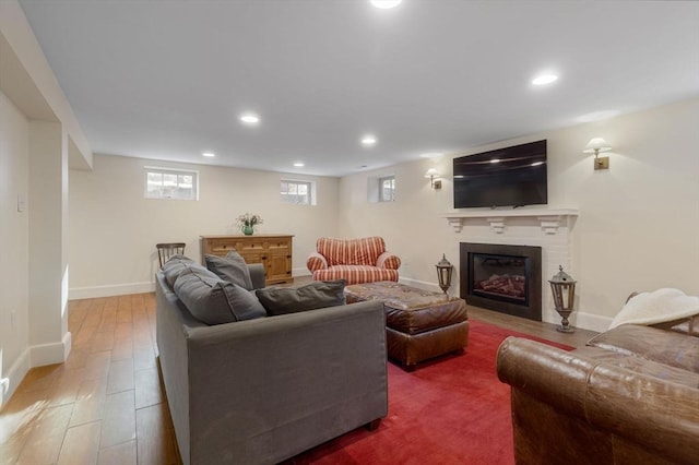 115 Rutledge, Belmont, MA 02478 - living area featuring wood finished floors, a glass covered fireplace, baseboards, and recessed lighting