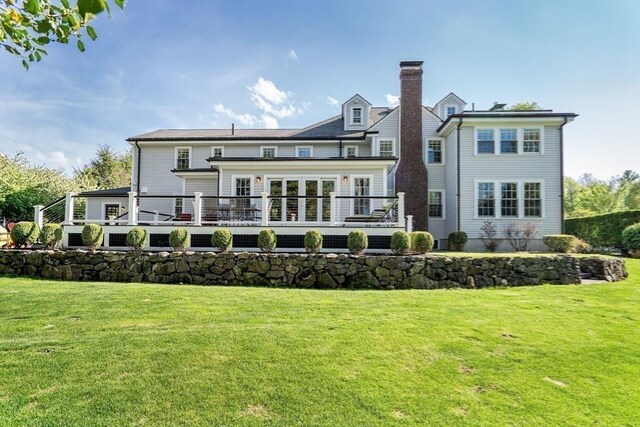 115 Rutledge, Belmont, MA 02478 - back of property featuring a deck, a lawn, and a chimney