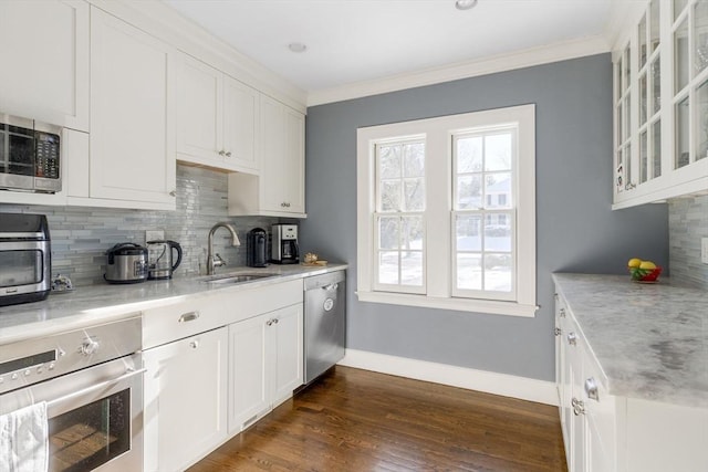 115 Rutledge, Belmont, MA 02478 - kitchen featuring a sink, appliances with stainless steel finishes, baseboards, tasteful backsplash, and white cabinetry