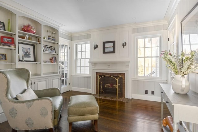 115 Rutledge, Belmont, MA 02478 - sitting room with dark wood-style flooring, a decorative wall, crown molding, a fireplace with flush hearth, and baseboards