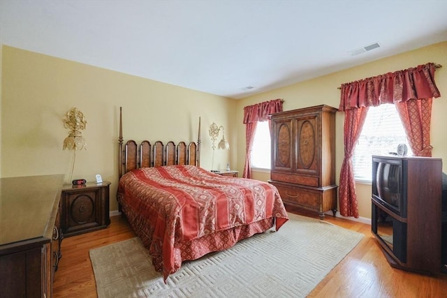 bedroom featuring visible vents and light wood finished floors