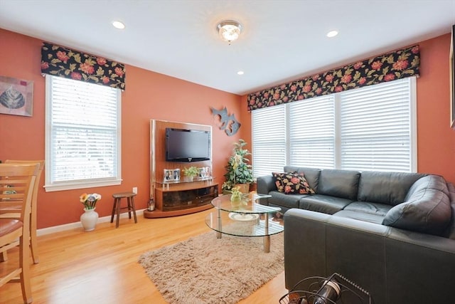 living room featuring recessed lighting, a wealth of natural light, and light wood-type flooring