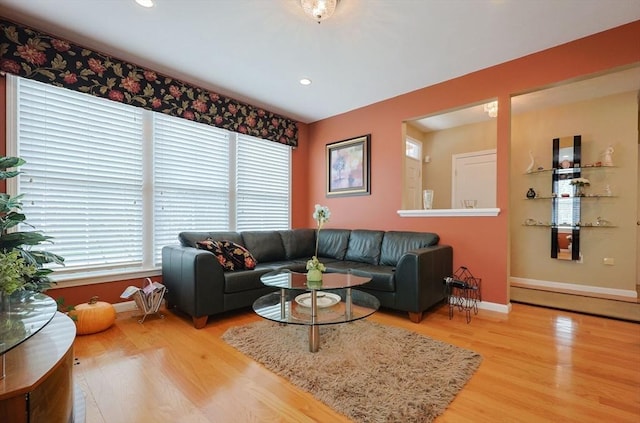 living room featuring baseboards, recessed lighting, and wood finished floors