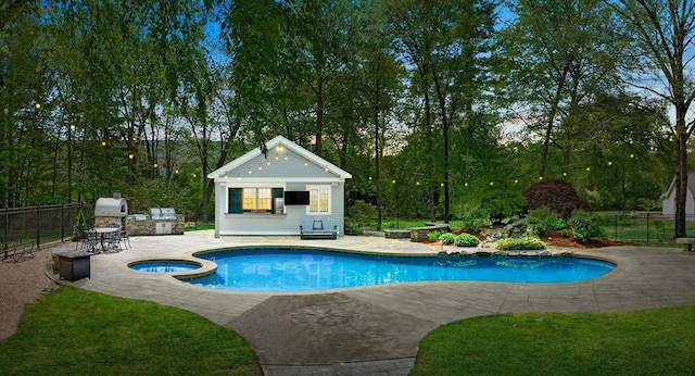 view of pool with a storage structure, a patio area, an outbuilding, and fence