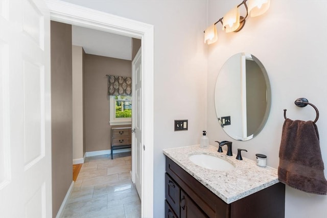 bathroom with baseboards and vanity