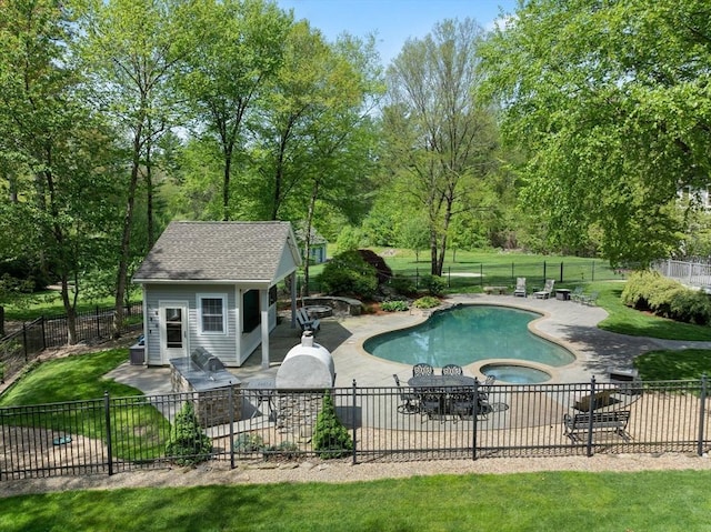 view of pool with a patio area, an outbuilding, a storage structure, and an in-ground hot tub