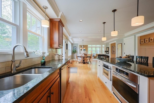 185 Read St, Seekonk, MA 02771 - kitchen with a sink, brown cabinetry, stainless steel appliances, healthy amount of natural light, and crown molding