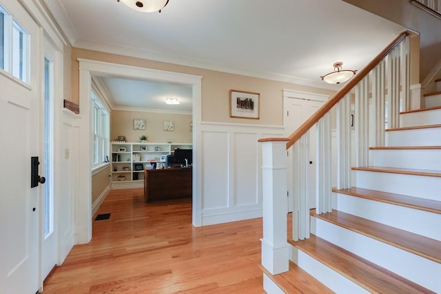 185 Read St, Seekonk, MA 02771 - foyer with stairs, ornamental molding, a decorative wall, light wood-style flooring, and wainscoting