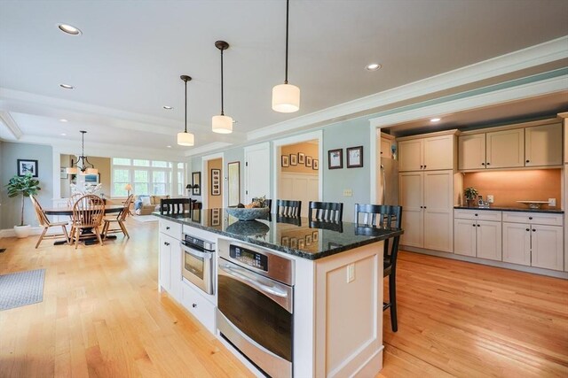 185 Read St, Seekonk, MA 02771 - kitchen with oven, a kitchen bar, light wood finished floors, crown molding, and recessed lighting