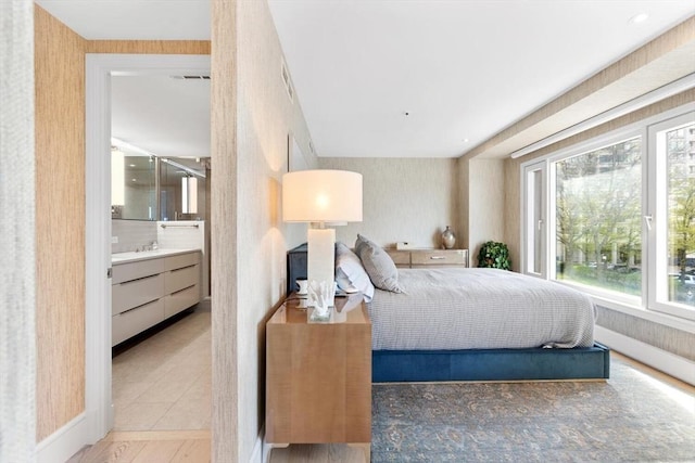 bedroom with connected bathroom and radiator heating unit