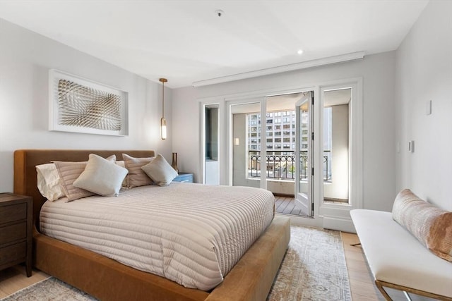 bedroom with access to outside, light wood-style floors, and recessed lighting