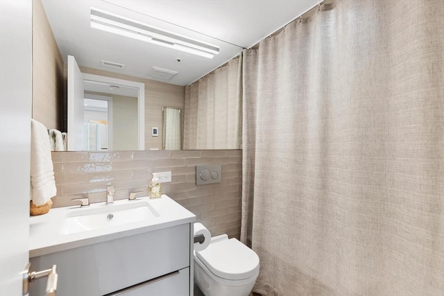 bathroom featuring tile walls, toilet, vanity, decorative backsplash, and a shower with shower curtain