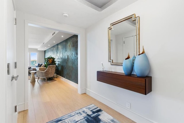 corridor featuring wood finished floors, baseboards, and recessed lighting