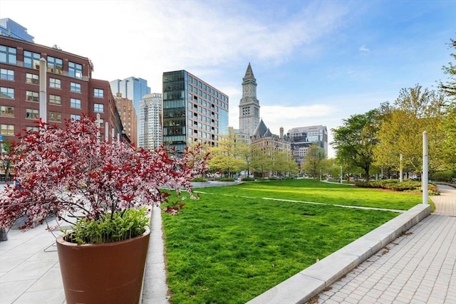 view of home's community featuring a city view and a yard