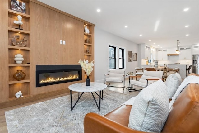 living room with light hardwood / wood-style floors and built in features