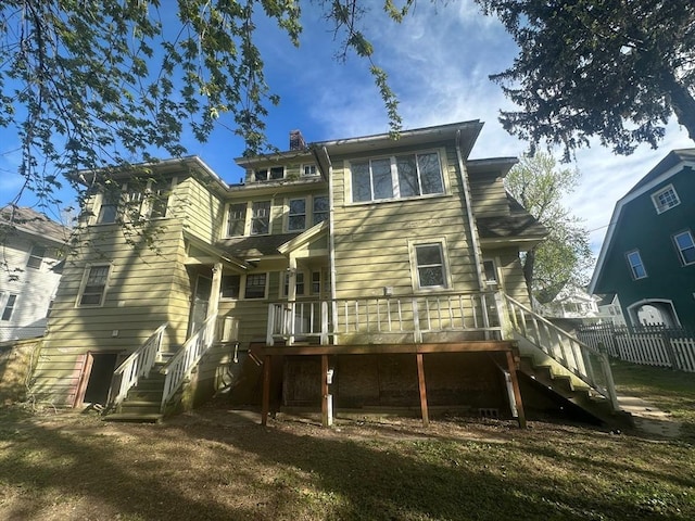 back of house featuring stairs, fence, and a deck