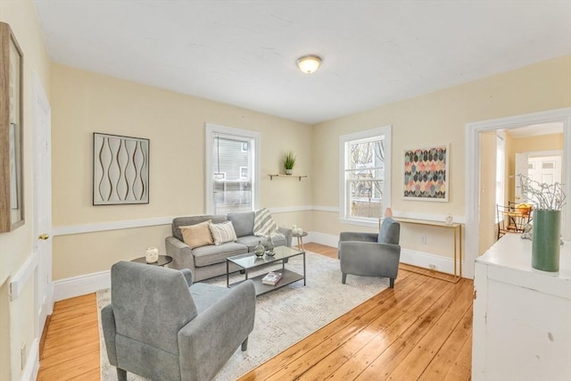living room featuring light wood-style flooring and baseboards