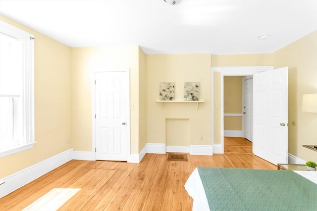 unfurnished bedroom featuring light wood-style floors and baseboards