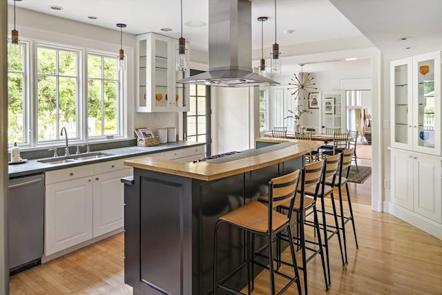 44 Ripley Hill Rd, Concord, MA 01742 - kitchen featuring wooden counters, stainless steel dishwasher, island exhaust hood, light wood-type flooring, and a kitchen island