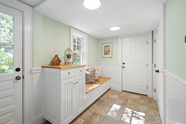 44 Ripley Hill Rd, Concord, MA 01742 - mudroom with a wainscoted wall, a decorative wall, and light stone finish flooring