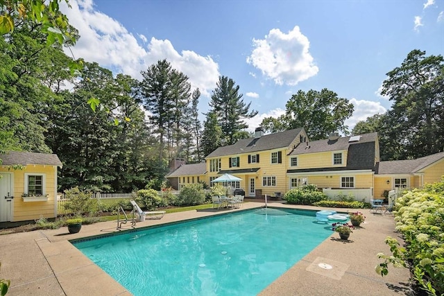 44 Ripley Hill Rd, Concord, MA 01742 - swimming pool featuring a patio and view of scattered trees