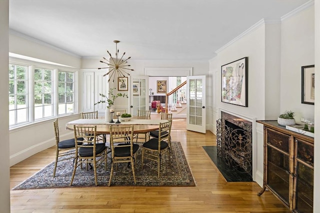 44 Ripley Hill Rd, Concord, MA 01742 - dining room featuring crown molding, healthy amount of natural light, light wood-style floors, a fireplace, and stairs