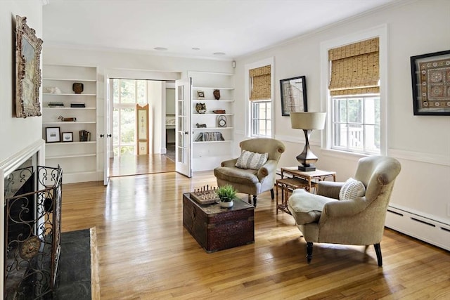 44 Ripley Hill Rd, Concord, MA 01742 - living area with crown molding, wood finished floors, built in features, a premium fireplace, and a baseboard heating unit