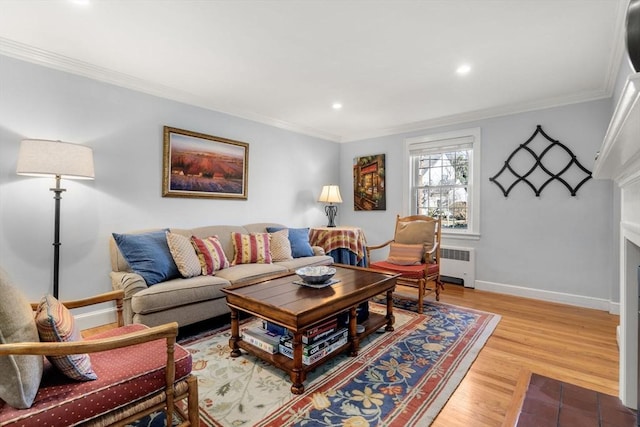 living room featuring radiator, hardwood / wood-style flooring, and ornamental molding