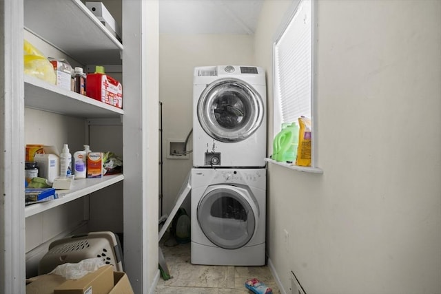 washroom with stacked washer / drying machine