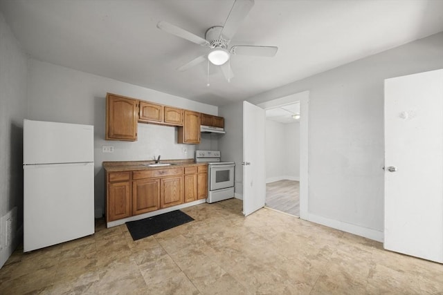 kitchen featuring white appliances, a sink, under cabinet range hood, a ceiling fan, and brown cabinetry