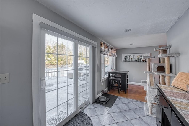 doorway to outside featuring light tile patterned floors