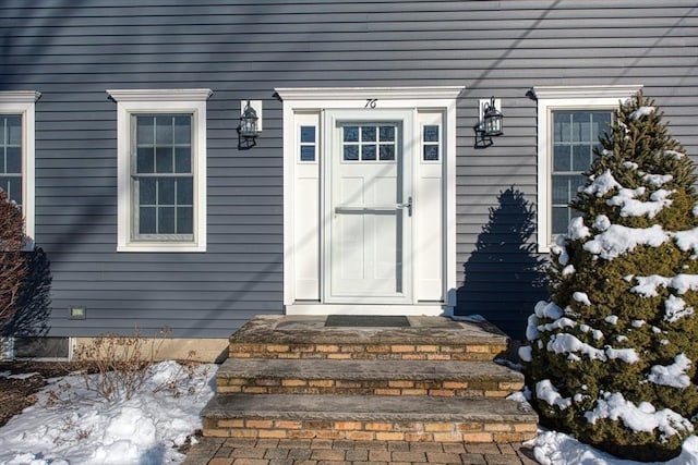 view of snow covered property entrance