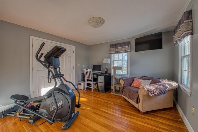 workout area with hardwood / wood-style flooring