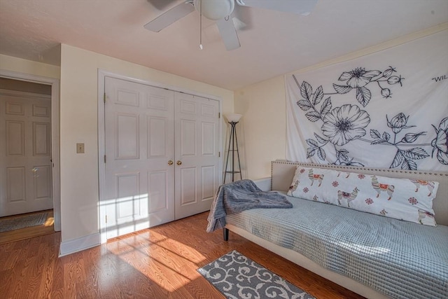 bedroom featuring ceiling fan, hardwood / wood-style floors, and a closet