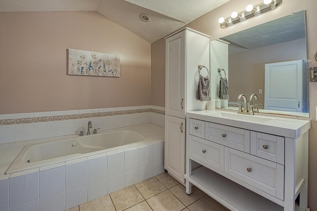 bathroom featuring vanity, vaulted ceiling, tiled tub, and tile patterned floors