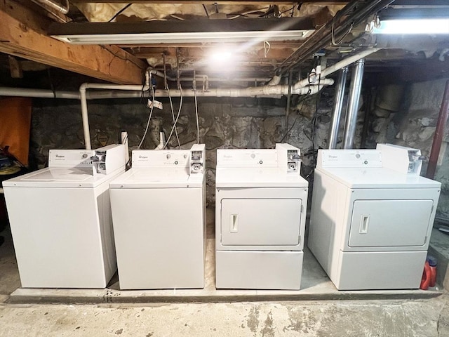 washroom with independent washer and dryer and laundry area