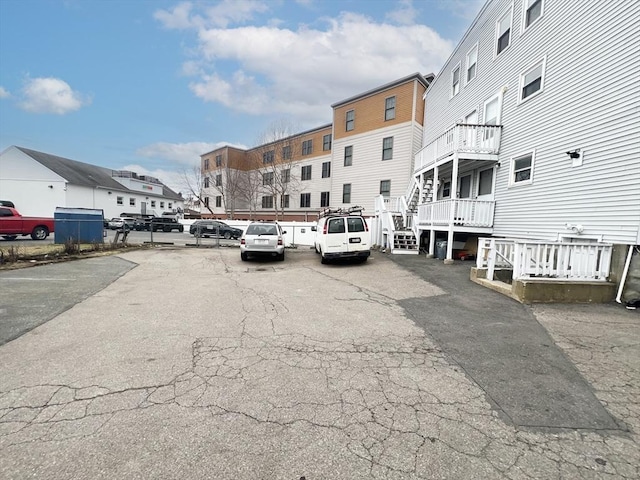 uncovered parking lot featuring a residential view