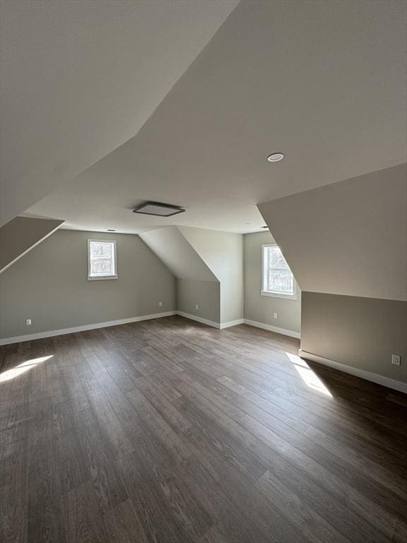 bonus room featuring lofted ceiling, wood finished floors, and baseboards