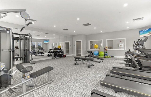 exercise room featuring light colored carpet