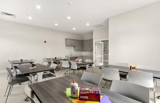 dining area featuring light tile patterned floors and sink