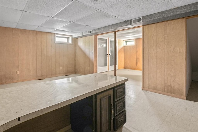 4 Fiske Mill Rd, Upton, MA 01568 - basement with wood walls, light flooring, and a paneled ceiling