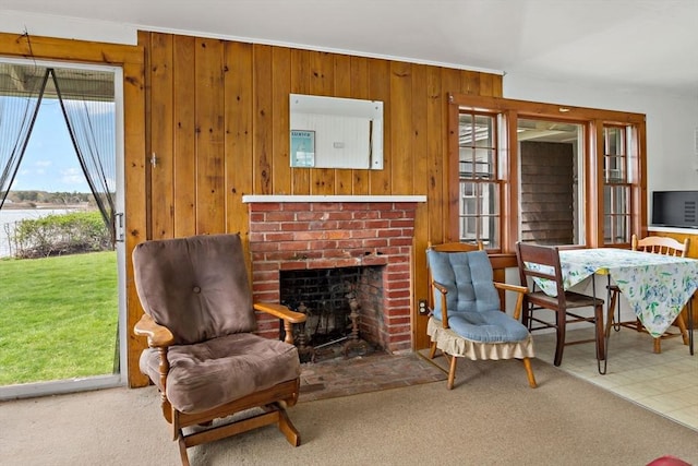 sitting room featuring wood walls and a fireplace