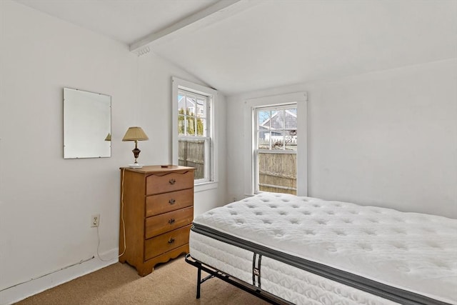 bedroom featuring lofted ceiling with beams, light colored carpet, and baseboards
