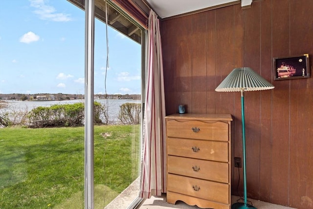 doorway featuring wooden walls and a water view