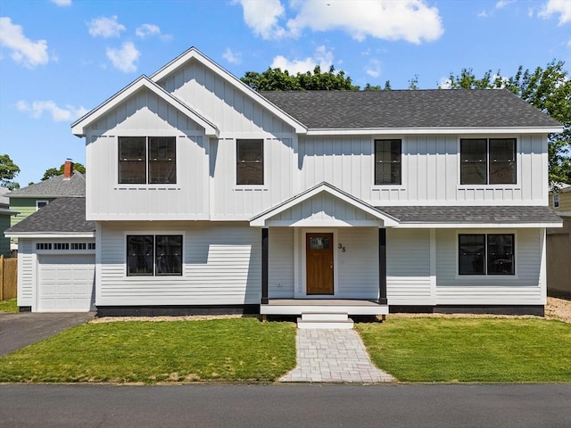 35 Columbia Ave, Lynn, MA 01902 - view of front of house featuring board and batten siding, roof with shingles, a porch, and a front yard