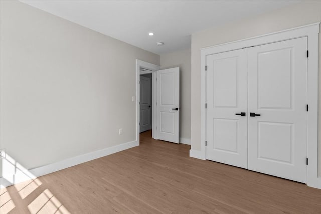 35 Columbia Ave, Lynn, MA 01902 - unfurnished bedroom with baseboards, light wood finished floors, recessed lighting, and a closet