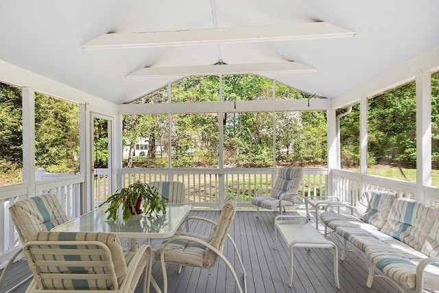 sunroom / solarium featuring outdoor dining area, outdoor lounge area, a healthy amount of sunlight, and beam ceiling