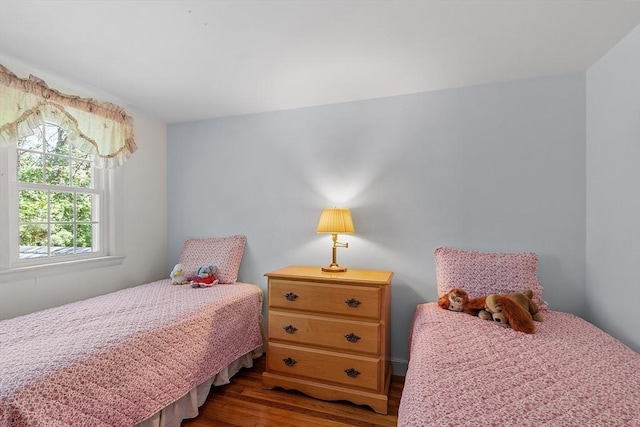 bedroom with dark wood-type flooring