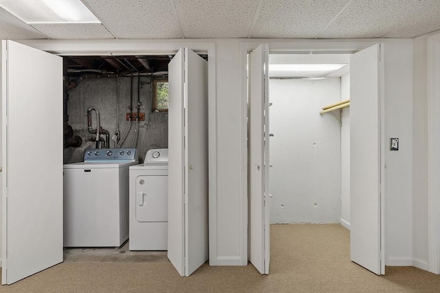 washroom featuring separate washer and dryer and light colored carpet